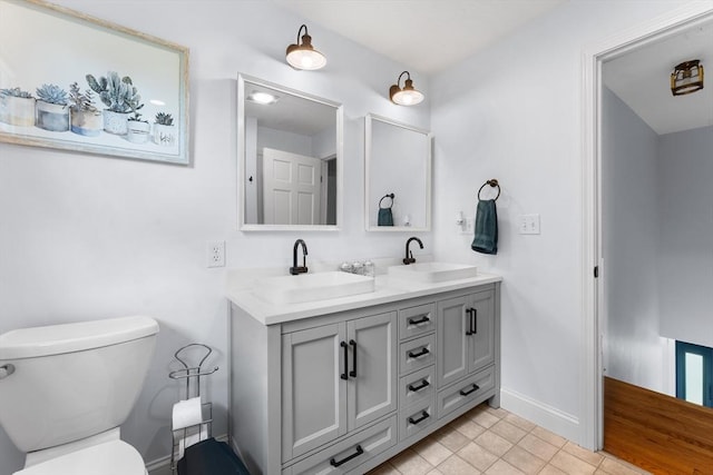 26 Dodge Rd, Sutton, MA 01590 - full bath with double vanity, toilet, baseboards, and tile patterned flooring