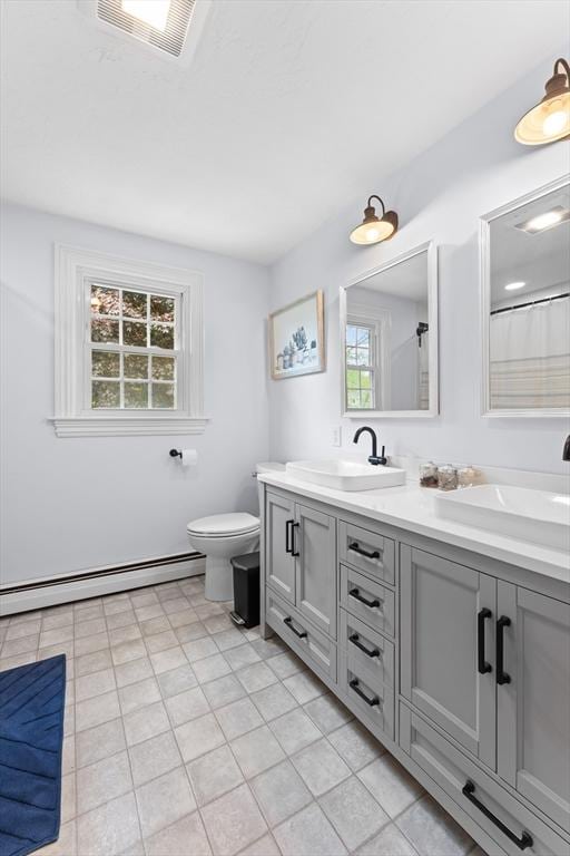 26 Dodge Rd, Sutton, MA 01590 - bathroom with a baseboard radiator, double vanity, healthy amount of natural light, and toilet