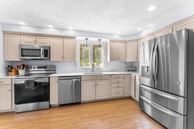 26 Dodge Rd, Sutton, MA 01590 - kitchen featuring stainless steel appliances, a sink, light countertops, light wood-style flooring, and decorative light fixtures