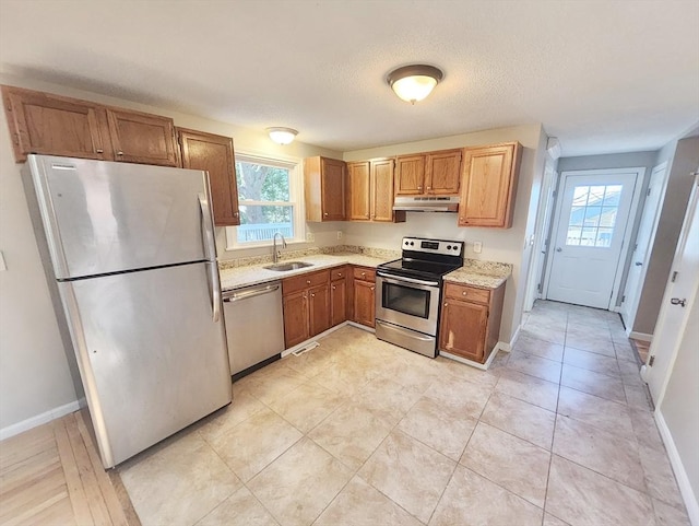 kitchen featuring sink, a textured ceiling, and appliances with stainless steel finishes