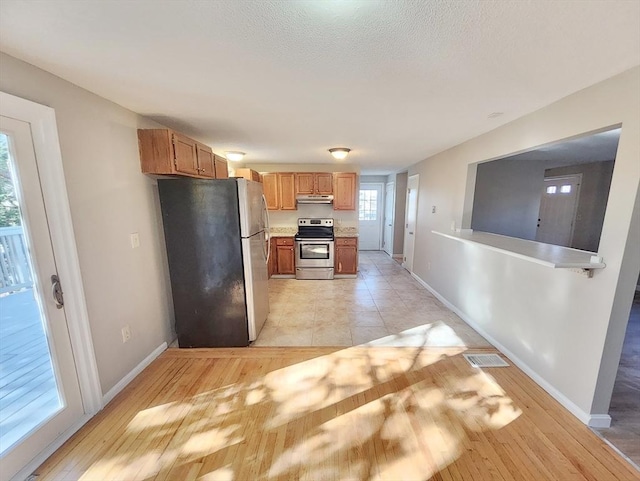 kitchen with stainless steel appliances and light hardwood / wood-style flooring