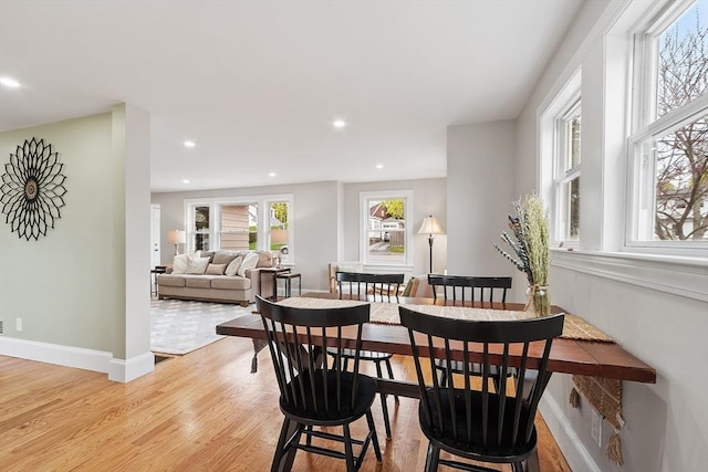 dining room featuring light wood-style floors, baseboards, and recessed lighting