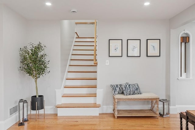 stairway featuring recessed lighting, baseboards, wood finished floors, and visible vents