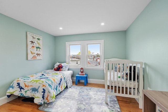 bedroom with baseboards, recessed lighting, and wood finished floors
