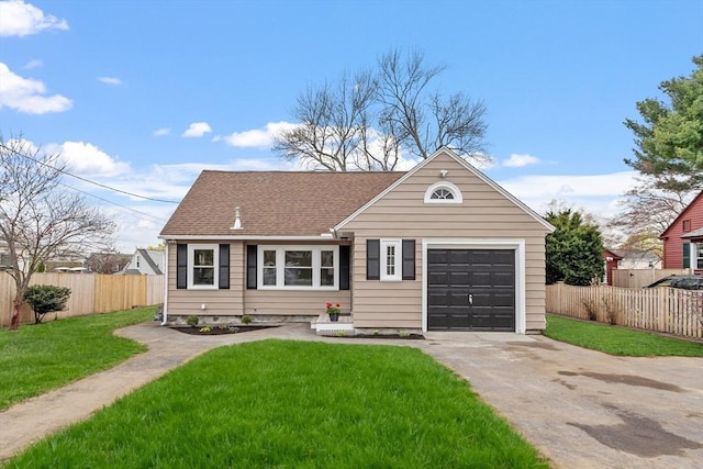 view of front of property with fence, roof with shingles, a front lawn, a garage, and concrete driveway