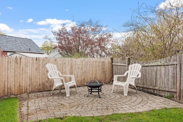 view of patio / terrace with a fenced backyard and a fire pit