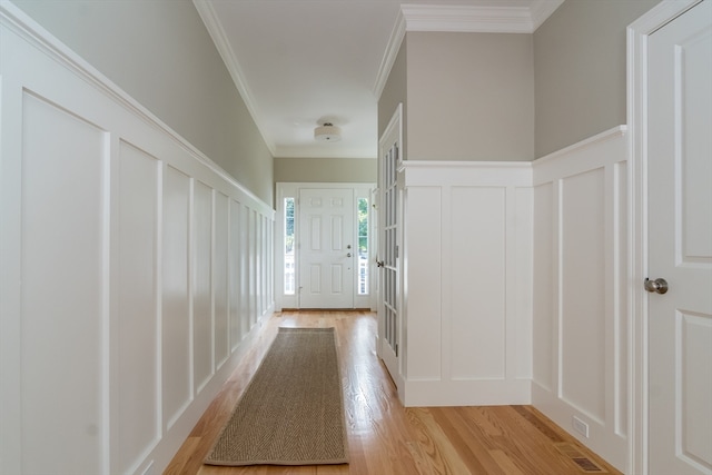 hallway featuring light hardwood / wood-style flooring and ornamental molding