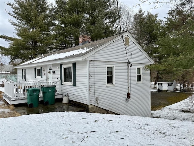 exterior space with a chimney and a wooden deck