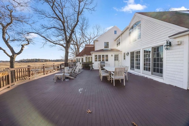 wooden terrace featuring a grill and a rural view