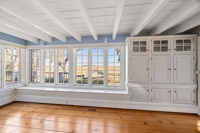 interior space with beamed ceiling and a healthy amount of sunlight