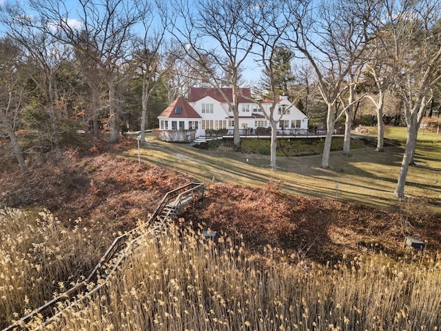 back of property featuring a yard