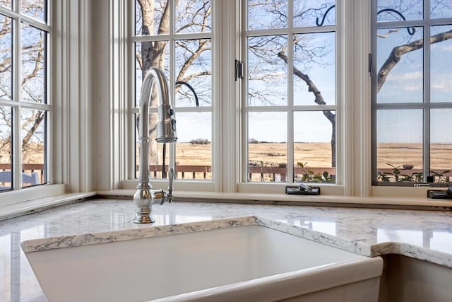 details featuring sink and light stone countertops