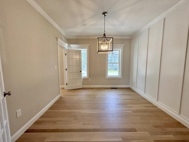 6 Knott St, Attleboro, MA 02703 - unfurnished dining area with light wood-style flooring, a chandelier, and crown molding