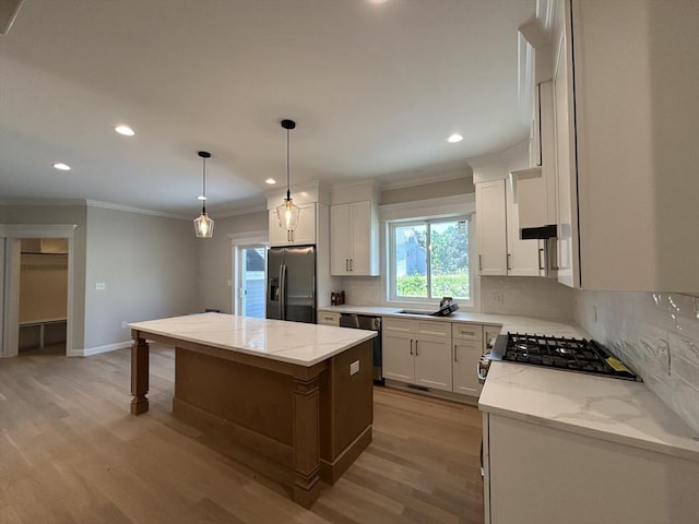 6 Knott St, Attleboro, MA 02703 - kitchen featuring stainless steel appliances, ornamental molding, light wood finished floors, backsplash, and a center island