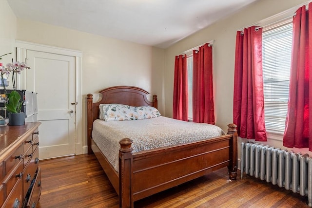 bedroom featuring radiator and dark wood finished floors