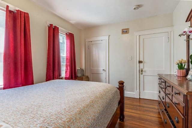 bedroom featuring dark wood-type flooring and baseboards