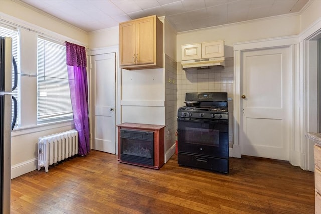 kitchen with radiator, decorative backsplash, dark wood-type flooring, black gas stove, and under cabinet range hood