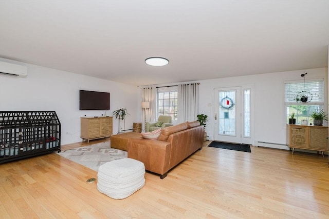 85 Evelyns Way, Fall River, MA 02724 - living room with a wall mounted AC, baseboard heating, and wood finished floors