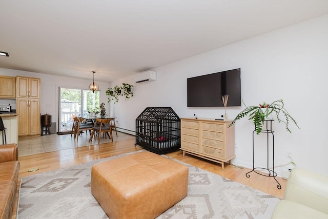 85 Evelyns Way, Fall River, MA 02724 - living room with a wall unit AC, light wood-style floors, and a baseboard heating unit