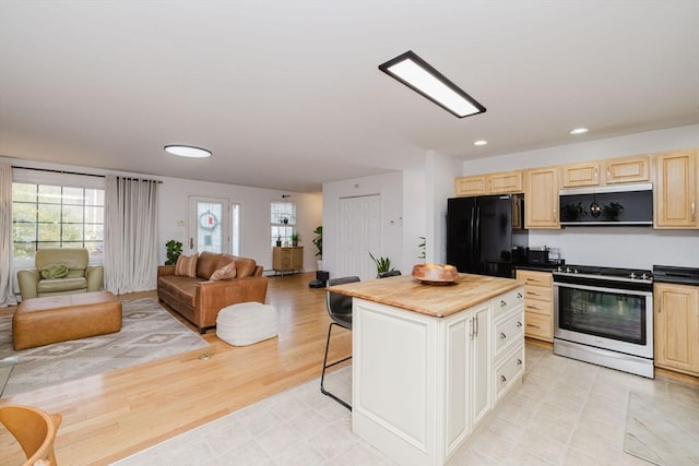 85 Evelyns Way, Fall River, MA 02724 - kitchen with freestanding refrigerator, stainless steel gas range oven, open floor plan, light brown cabinets, and recessed lighting