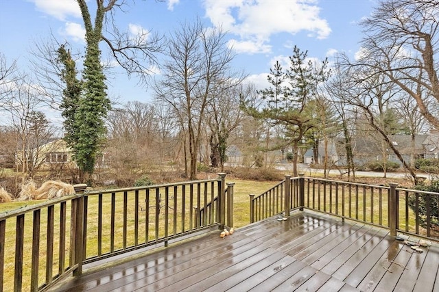 wooden deck featuring a yard