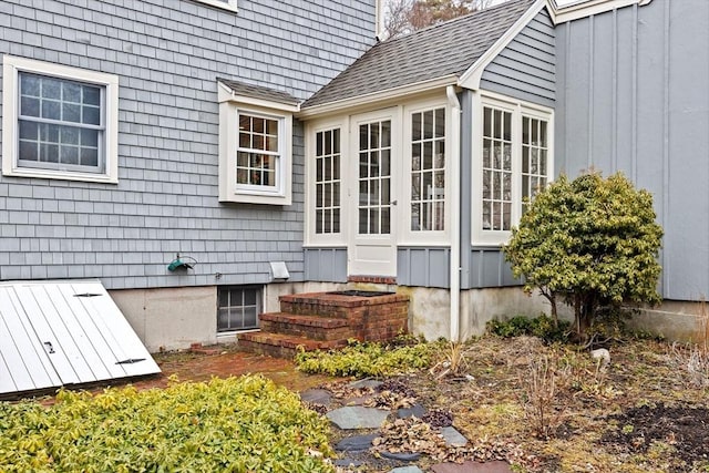 view of side of property featuring roof with shingles