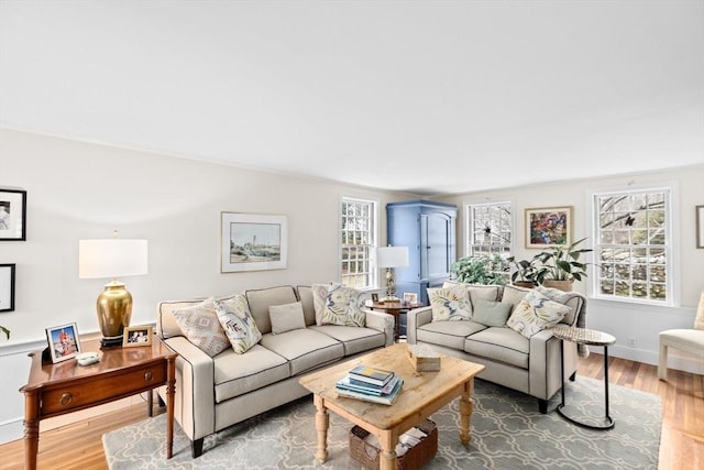 living area with baseboards and wood finished floors