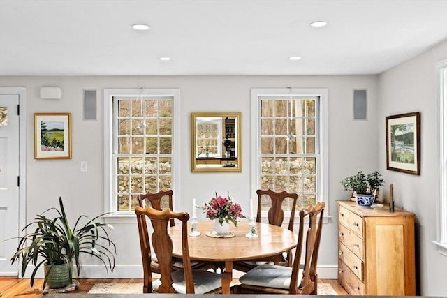 dining room featuring light wood finished floors, baseboards, and recessed lighting