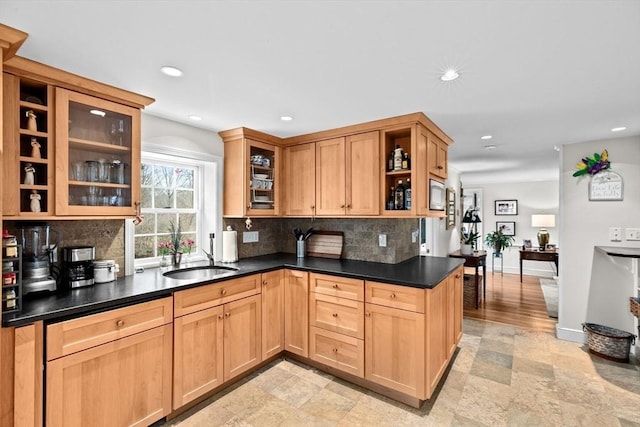 kitchen featuring recessed lighting, a sink, open shelves, tasteful backsplash, and dark countertops