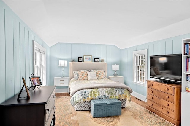 bedroom featuring lofted ceiling and wood finished floors