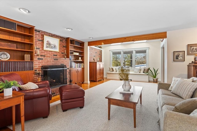 living room with a brick fireplace