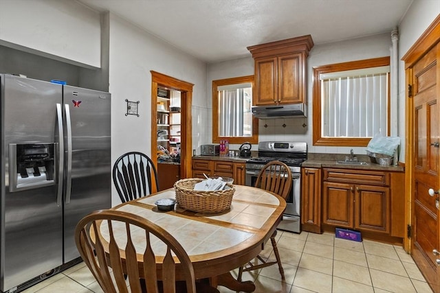 kitchen featuring sink, light tile patterned flooring, backsplash, and stainless steel appliances