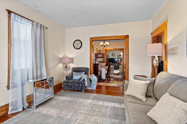 living room featuring wood-type flooring and a chandelier