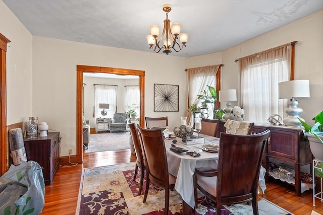 dining space with a notable chandelier and hardwood / wood-style flooring