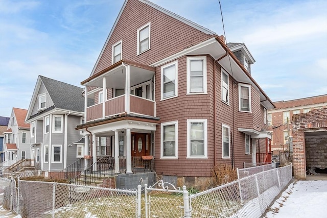 view of front of property featuring a balcony and covered porch