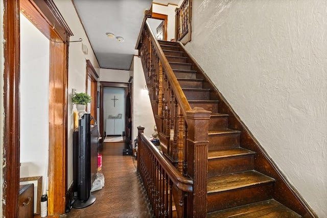 stairway with radiator heating unit and tile patterned floors