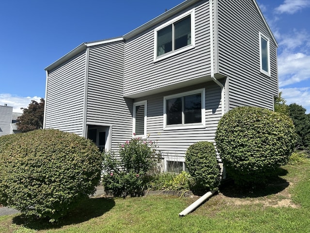 view of home's exterior with a yard