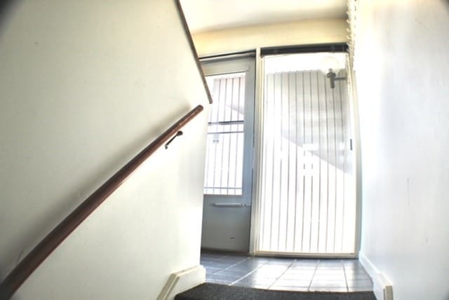 staircase with tile patterned floors