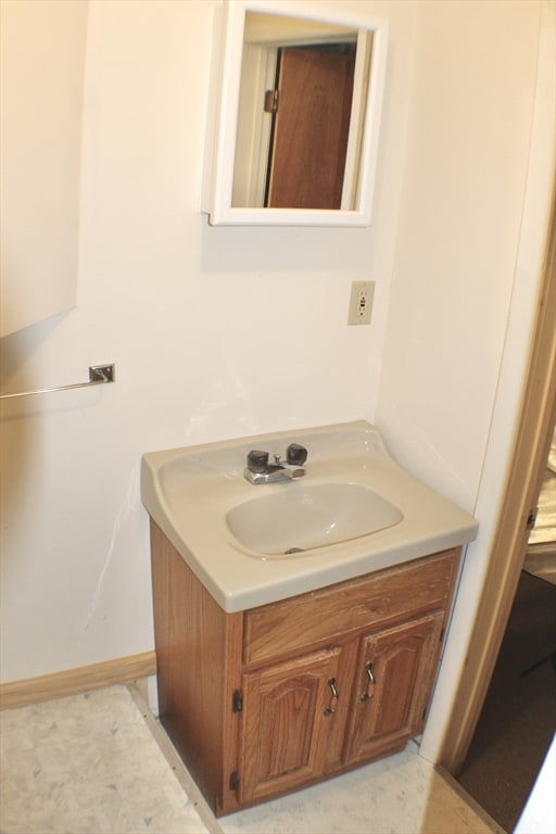 bathroom featuring baseboards and vanity