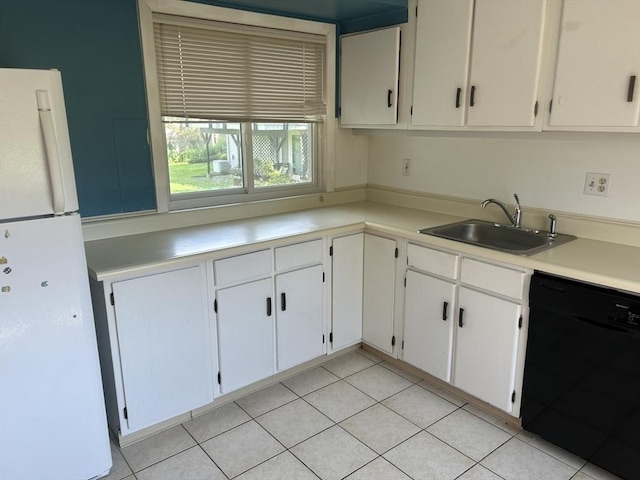 kitchen featuring a sink, white cabinets, black dishwasher, light countertops, and freestanding refrigerator