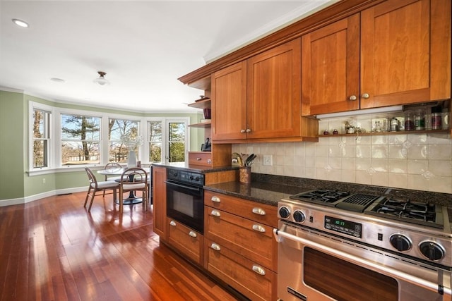 kitchen featuring dark wood-style flooring, open shelves, decorative backsplash, brown cabinetry, and gas stove