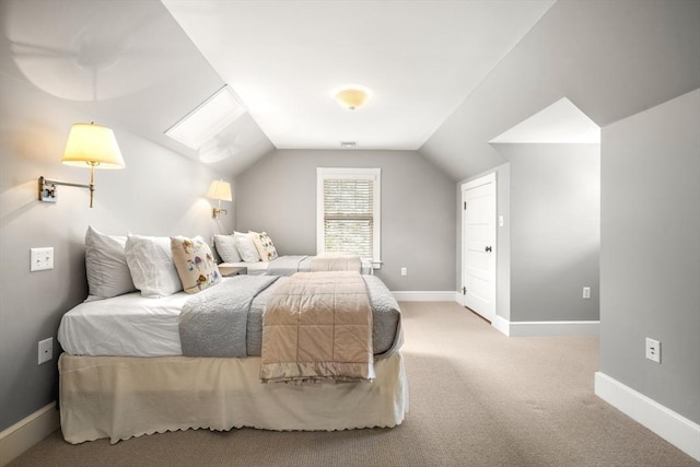 carpeted bedroom with lofted ceiling and baseboards