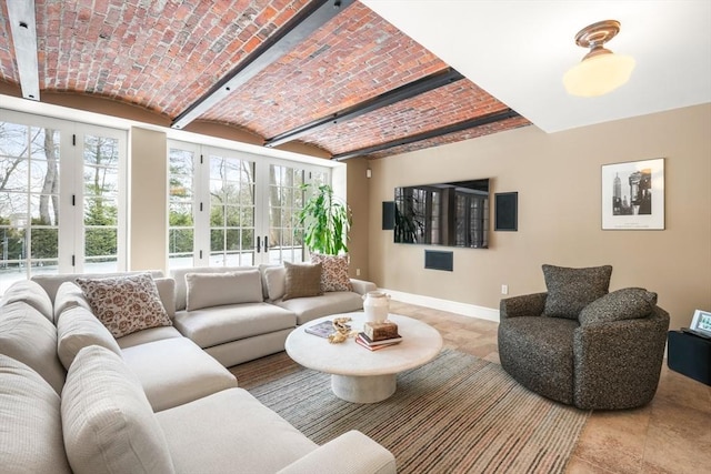 living room with brick ceiling and baseboards