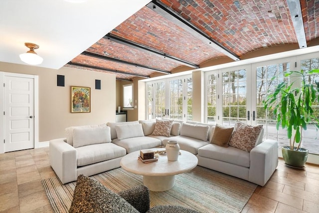 sunroom featuring brick ceiling and french doors