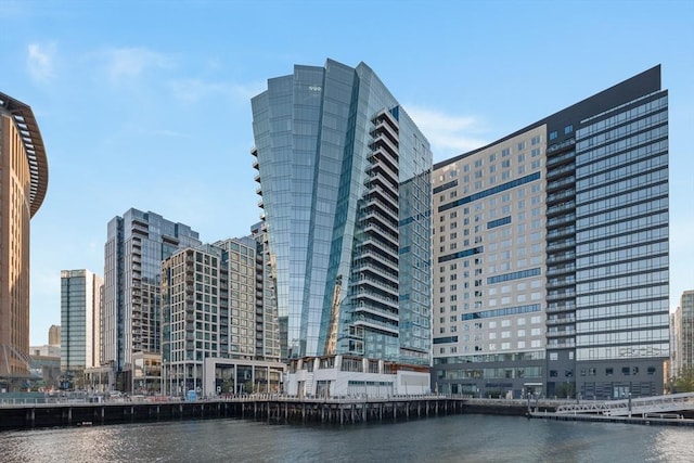 view of property with a water view and a city view