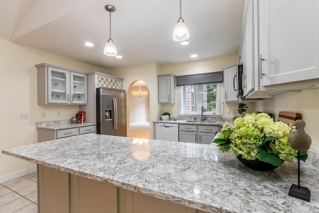 kitchen with decorative light fixtures, kitchen peninsula, and stainless steel appliances