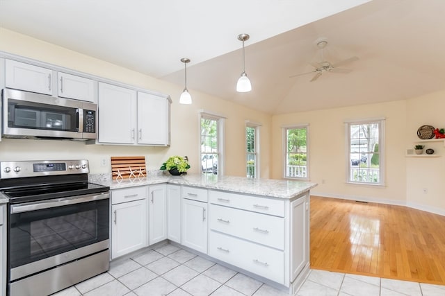 kitchen with white cabinets, light wood-type flooring, and appliances with stainless steel finishes