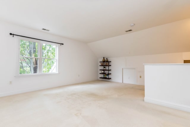 bonus room featuring light carpet and vaulted ceiling