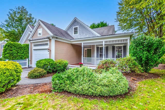 view of front of house featuring covered porch and a garage