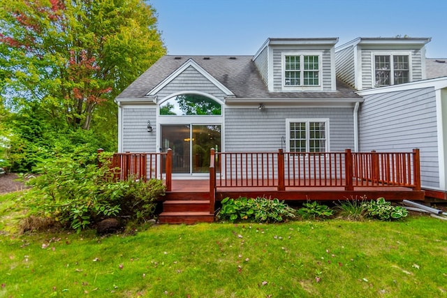 back of house with a deck and a yard